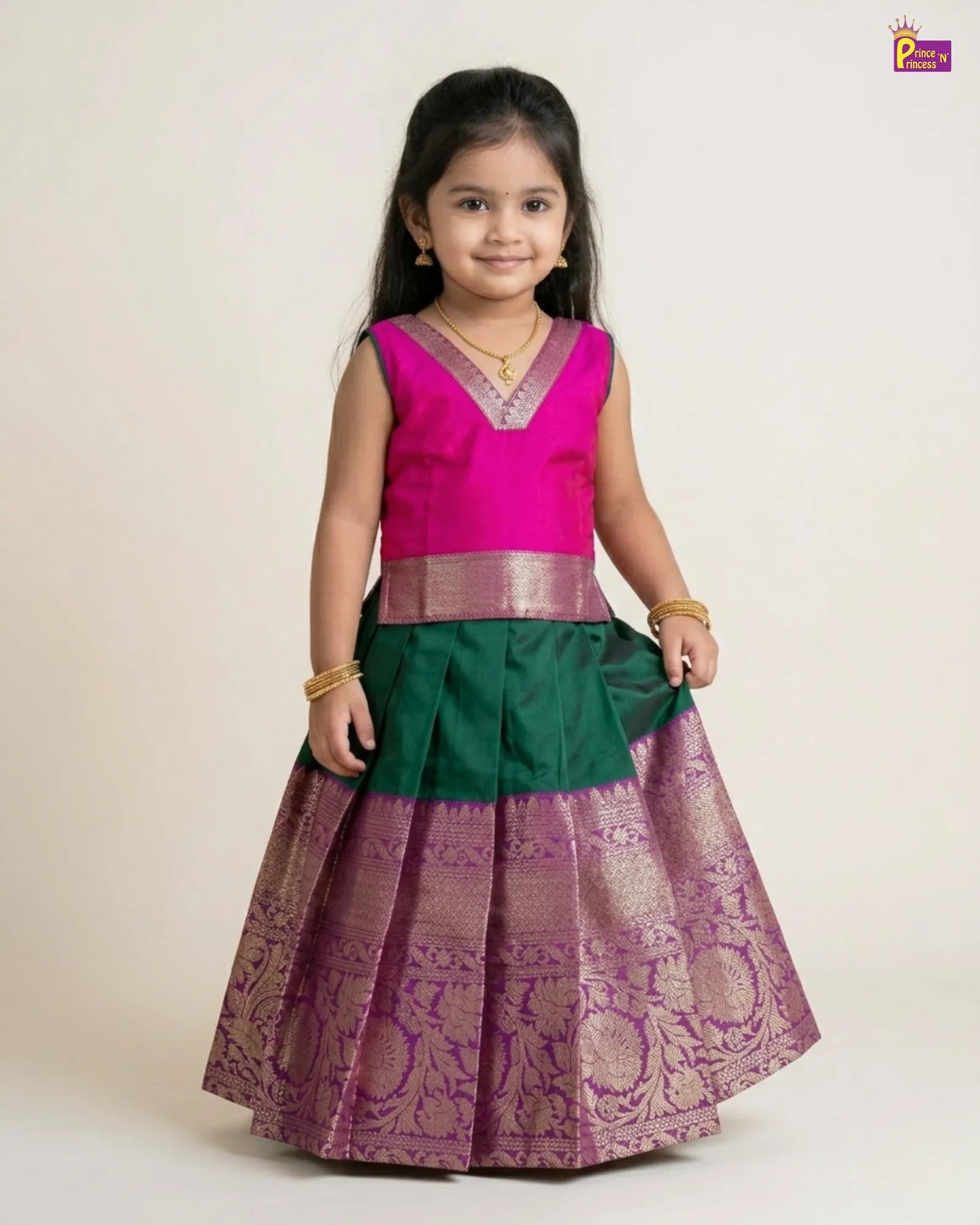 Young girl wearing a traditional outfit with a pink blouse and green and purple skirt on a white background